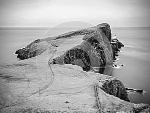 Cliffs of Neist Point Cape and lighthouse in black and white.