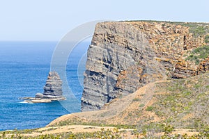 Cliffs, ocean, mountains and vegetation in Arrifana