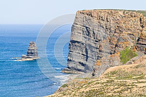Cliffs, ocean, mountains and vegetation in Arrifana
