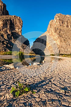 Cliffs rise steeply from Rio Grande River. A view of Santa Elena Canyon in Big Bend National Park