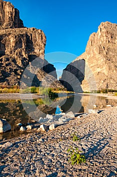 Cliffs rise steeply from Rio Grande River. A view of Santa Elena Canyon in Big Bend National Park