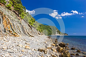 Cliffs, rocks and stones on the seashore on a clear day