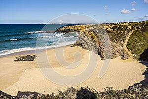 Cliffs and sand on Cerca Nova Beach, Alentejo, Portugal photo