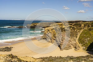 Cliffs and sand on Cerca Nova Beach, Alentejo, Portugal photo