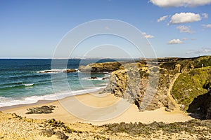 Cliffs and sand on Cerca Nova Beach, Alentejo, Portugal photo