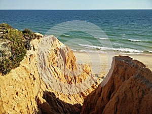 Cliffs on a sandy Beach of Gale Fontainhas in Melides, Portugal on a sunny day