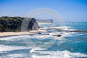 Cliffs and sandy beach on the Pacific Ocean coastline