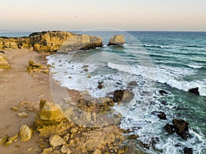 Cliffs on Sao Rafael beach by the Atlantic Ocean at sunset, Algarve, Portugal
