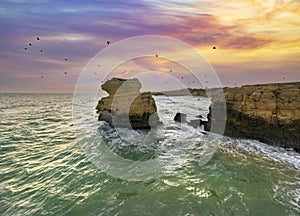 Cliffs on Sao Rafael beach by the Atlantic Ocean at sunset, Algarve, Portugal