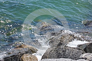 cliffs on the seashore and waves splashing on the rocks.