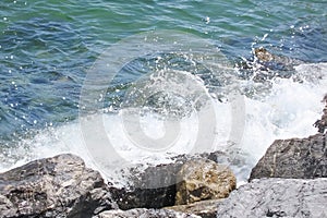 cliffs on the seashore and waves splashing on the rocks.