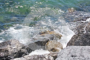 cliffs on the seashore and waves splashing on the rocks.