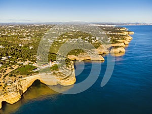 Cliffy coast with Alfazinha Lighthouse in Carvoeiro, Algarve, Portugal