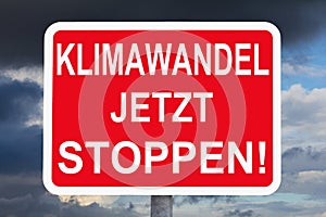 Warning sign KLIMAWANDEL JETZT STOPPEN photo