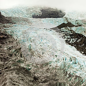 Climate change, melting glacier ice with crevasses