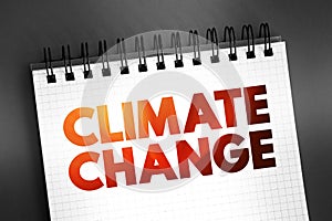 Climate change - refers to long-term shifts in temperatures and weather patterns, text concept on notepad