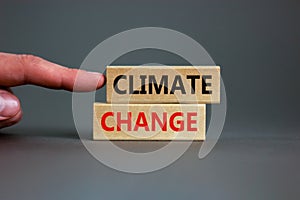 Climate change symbol. Wooden blocks with words `Climate change` on beautiful grey background. Businessman hand. Business,