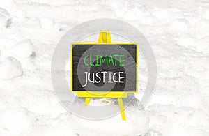 Climate justice symbol. Concept words Climate justice on beautiful black chalk blackboard. Chalkboard. Beautiful snow background.