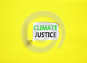 Climate justice symbol. Concept words Climate justice on beautiful white paper. Beautiful yellow paper background. Business