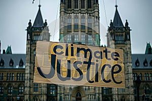 Climate Justice text on a banner outside the parliament Generative AI
