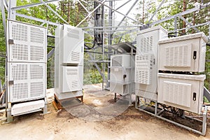 Climatic vandal-proof cabinets with microwave equipment and power cables, coaxial cables, optic fibers are installed near the mast
