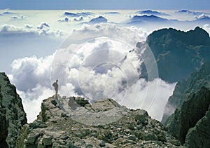 Climber admiring breathtaking mountain panorama
