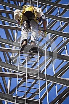 Climber ascending cell phone tower