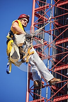 Climber ascending cell tower