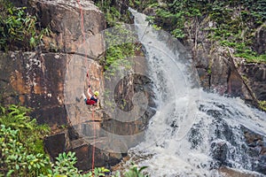 Climber in the background of beautiful cascading Datanla waterfall In the mountain town Dalat, Vietnam