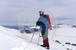 Climber on a background of a winter mountain landscape