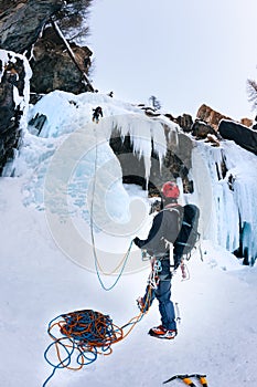 A climber belays the leader during a ice climbing.