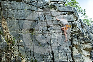 Climber climbing on top of a mountain with a safety
