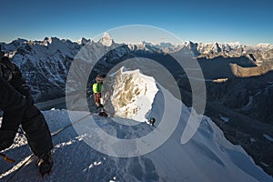 Climber climbing up to summit of Island peak in Everest region, Himalaya range in Nepal photo