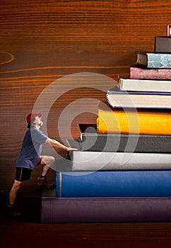 Climber climbs a heap of books