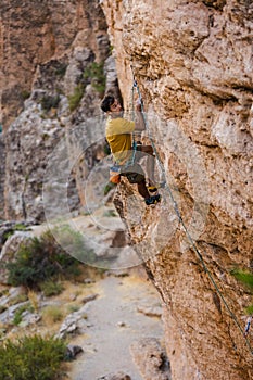 climber climbs the wall. a man is engaged in sport climbing