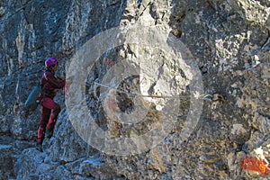 Climber on Dolomites mountains via ferrata