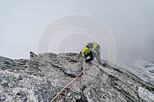 Climber on an extreme climb in the mountains.