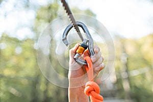 Climber fasten carbine on a rope
