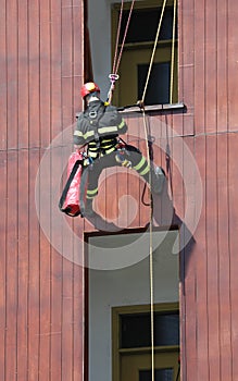 climber Firefighter during a training who enters from the window