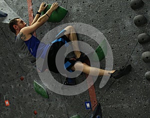 Climber flagging on green holds