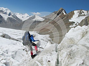 Climber going down from glacier with a rope