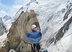 Climber looking on snow alpinist route photo