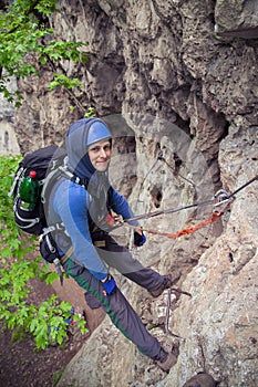 Climber man hanging on the rock