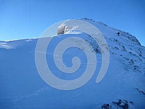 Climber at the mountain slope with snow