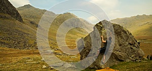 Climber on a rock to do Bouldering in the Lake District, United Kingdom.