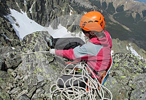 Climber with the rope on mountain summit
