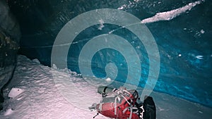 The climber's belongings lie inside an ice cave.