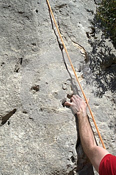 Climber`s hand holding on to rock