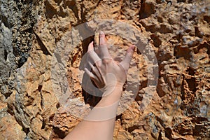 Climber`s hand holding on to rock
