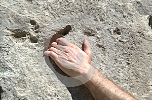 Climber`s hand holding on to rock